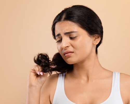 split-ends-upset-indian-woman-looking-her-damaged-hair-scaled-rfy5gubgazafen9in6fk49ke8i8dbiq18wmb2epjfk