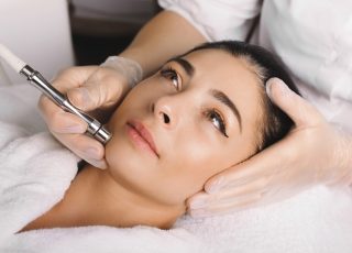 Lovely caucasian woman with black hair is waiting to finish her facial procedures at the spa salon hyperpigmentation treatments